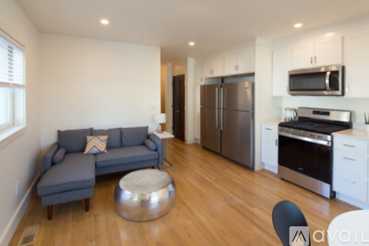 A kitchen with a refrigerator, oven, and microwave.