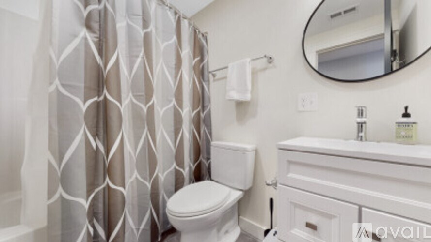 A white toilet sits next to a sink in a bathroom.