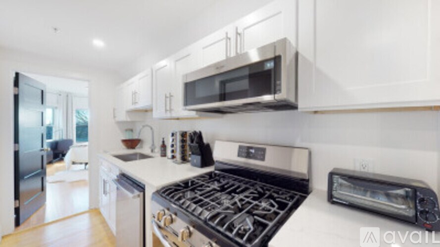 A modern kitchen with a stove top oven and microwave above it.