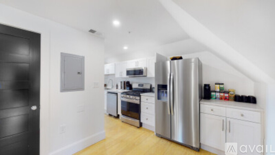 A kitchen with a refrigerator, oven, and microwave.