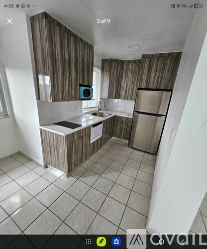 A kitchen with wooden cabinets and a white countertop.