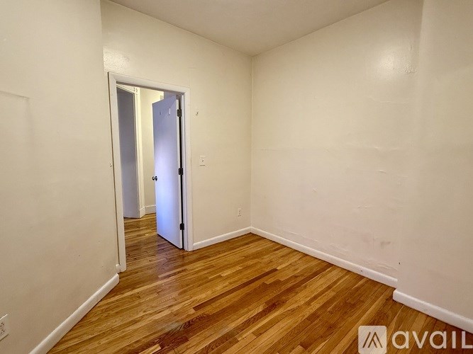 A room with wooden floors and a white door.