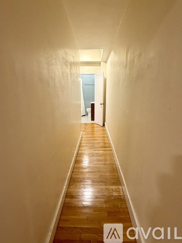 A long hallway with a door at the end.