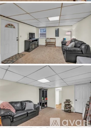 A living room with a couch and a television.