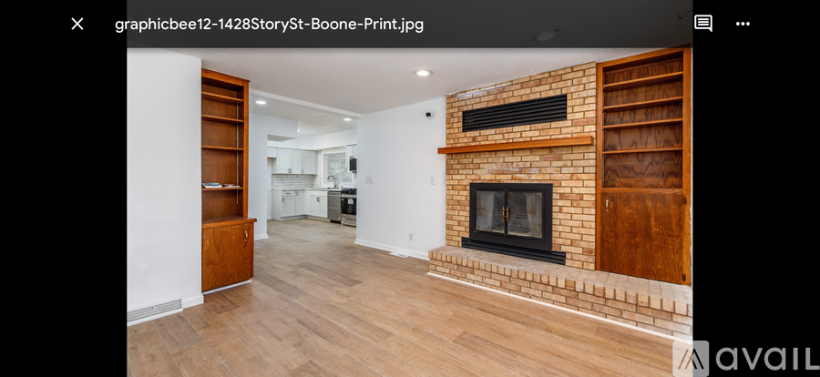 A modern living room with a fireplace and wooden flooring.