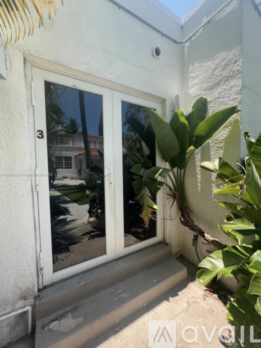 A white door with a glass window is numbered 3.