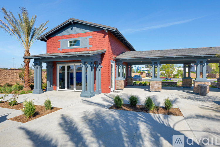 A red building with a blue roof and a porch with columns.