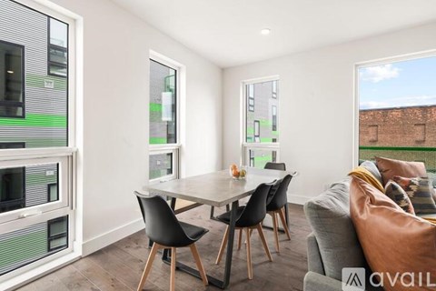 A modern dining room with a table set for four.