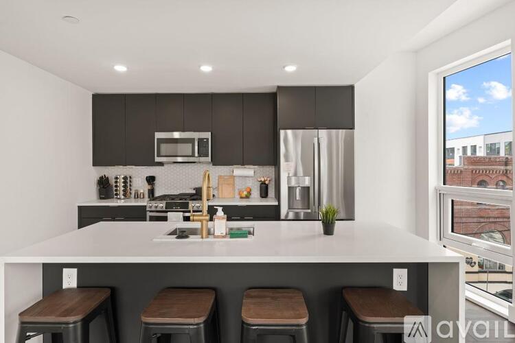 A modern kitchen with dark brown cabinets and white countertops.