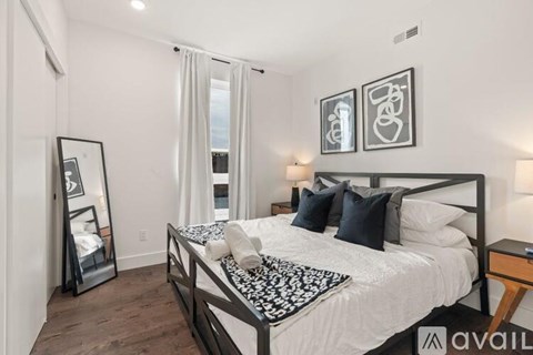 A bedroom with a large bed and a mirror on the wall.