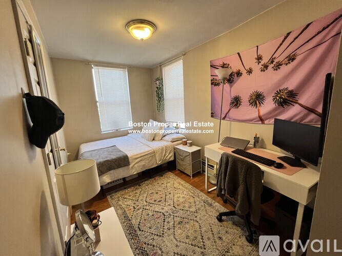 A bedroom with a bed, desk, and chair.
