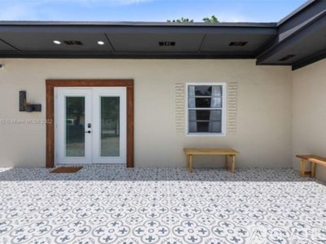 A house with a tiled floor and a bench outside.