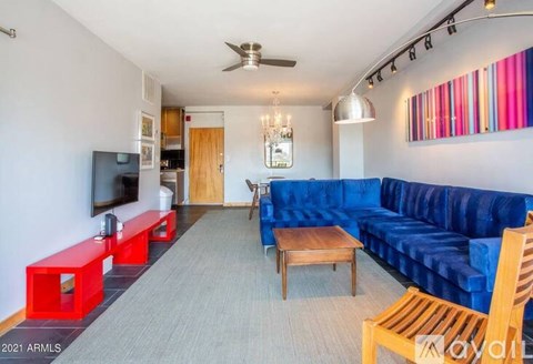 A living room with a blue couch and a television.