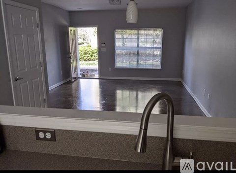 A kitchen with a sink and a window.