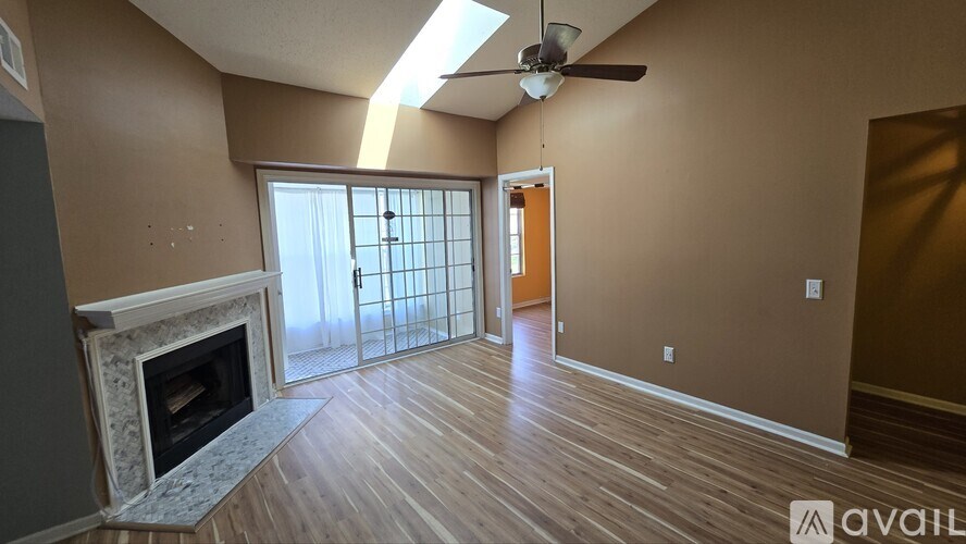 A room with a fireplace and sliding glass doors.
