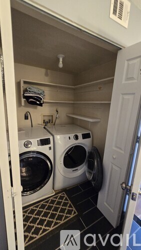 A small laundry room with two washing machines.