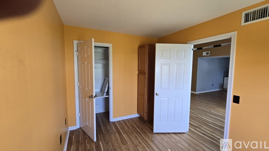 A room with yellow walls and a white door.