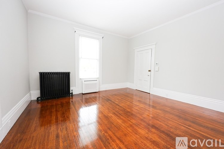A room with wooden floors and white walls.