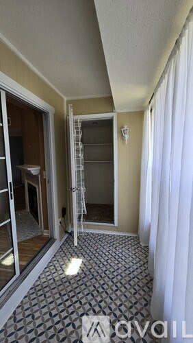 A shower with a black tile pattern and a square tile in the middle.
