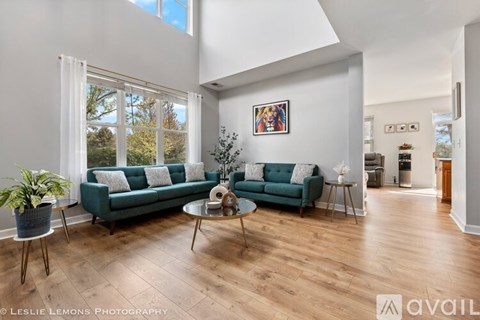 A living room with a green couch and a coffee table.