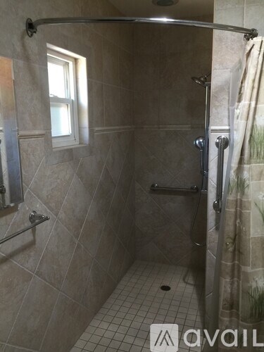 A tiled bathroom with a walk-in shower.