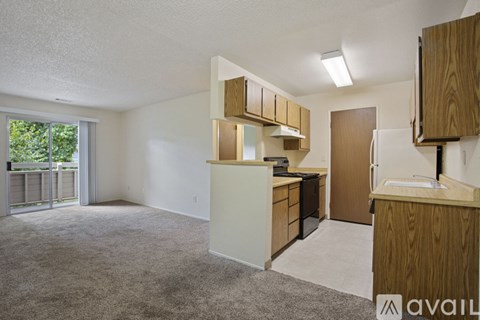 A kitchen with wooden cabinets and a white countertop.