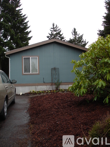 A house with a car parked in front of it.