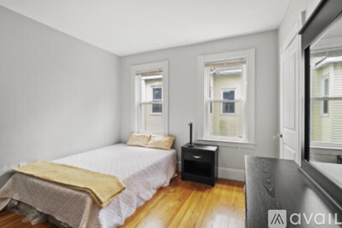 A bedroom with a bed, a dresser, and a window.