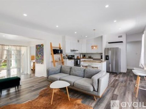 A modern living room with a grey sofa and a wooden coffee table.