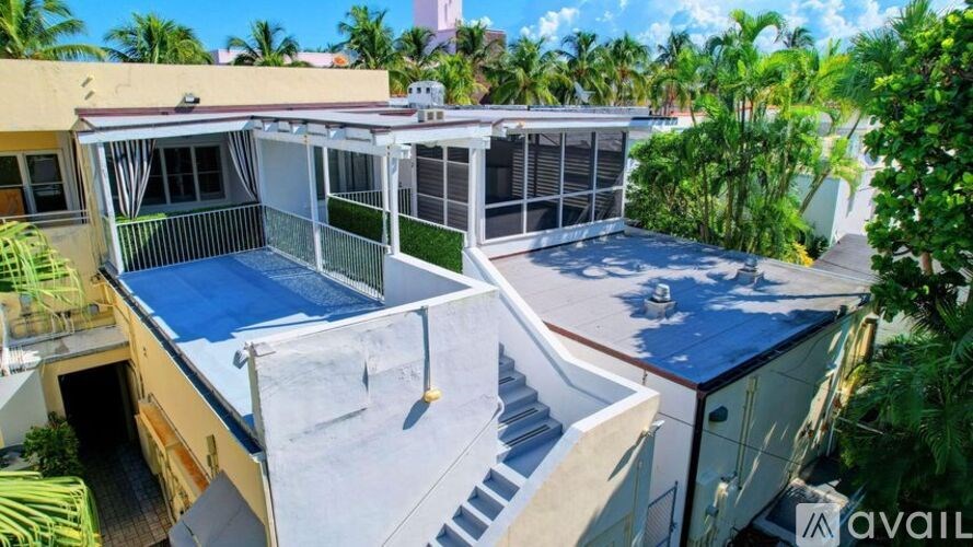 A rooftop pool area with a slide and lounging area.