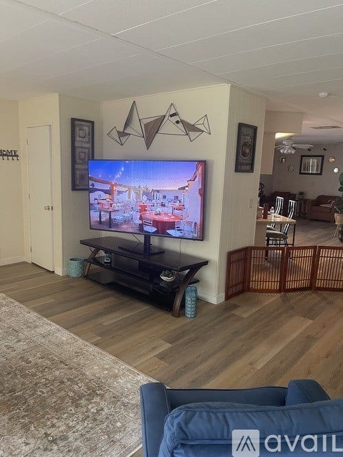 A living room with a television and a blue couch.