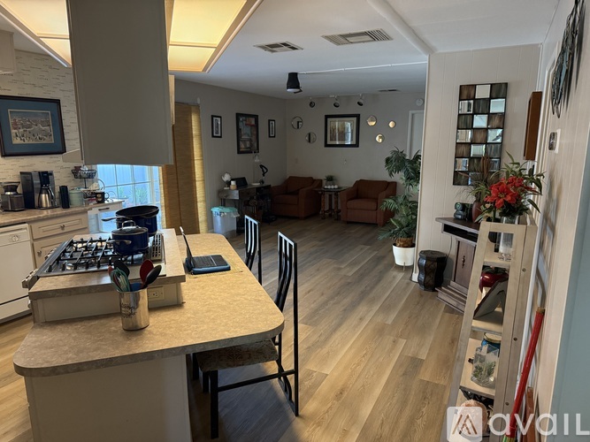 A kitchen with a table and chairs in the middle of the room.