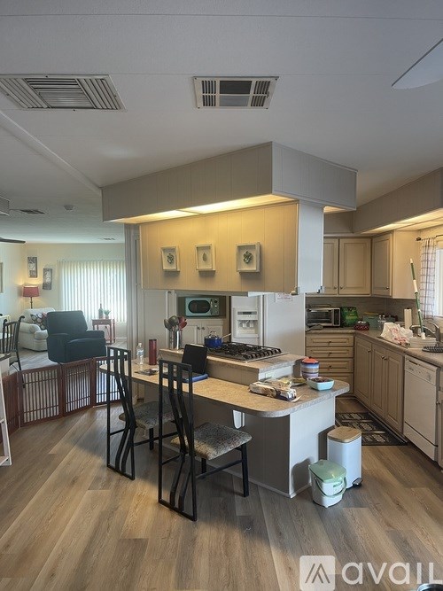 A kitchen with a table and chairs in the middle of the room.
