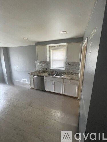 A kitchen with a window and a sink is available for rent.