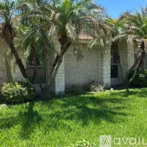 A house with a palm tree in front of it.