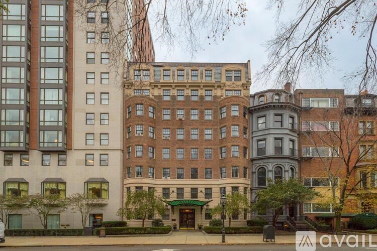A row of buildings with a green awning in front.