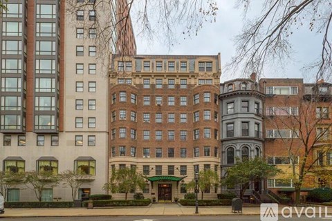 A row of buildings with a green awning in front.