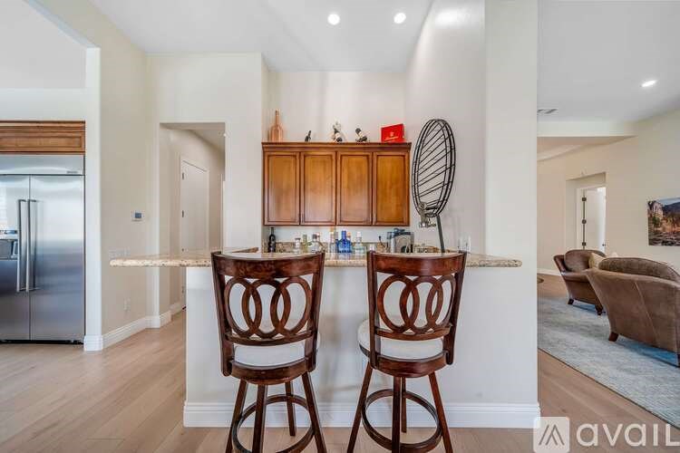 A kitchen with two chairs and a bar area.