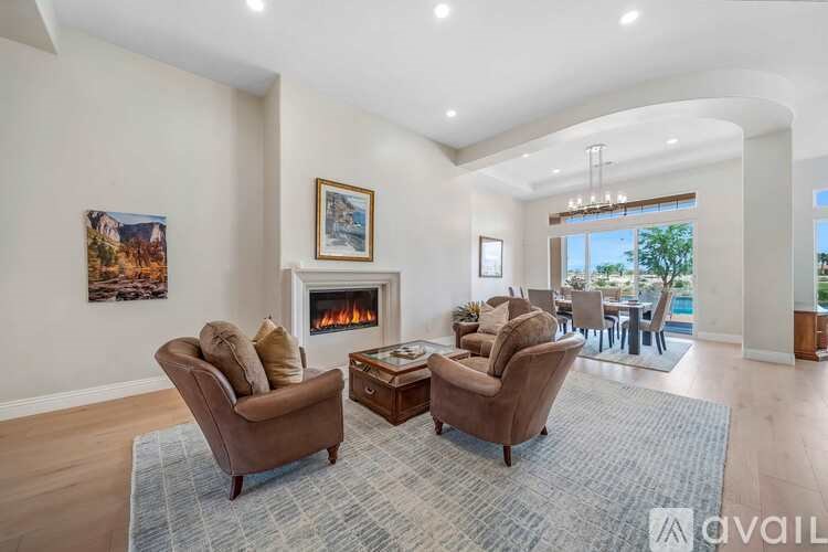 A living room with a fireplace and a large window.