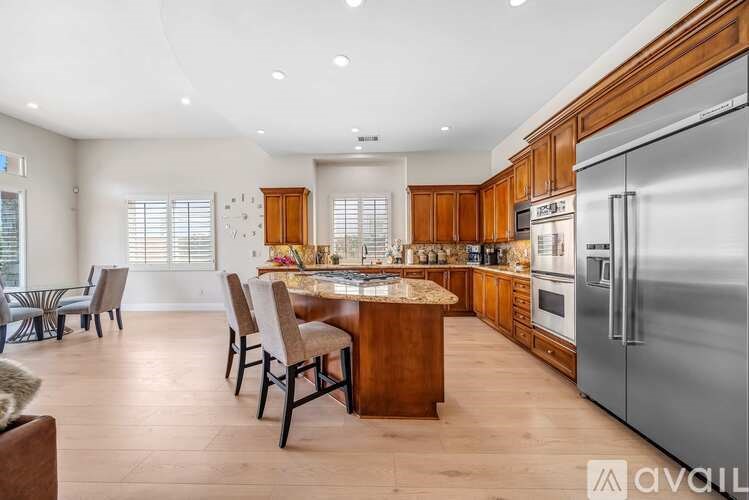 A modern kitchen with wooden cabinets and a center island.