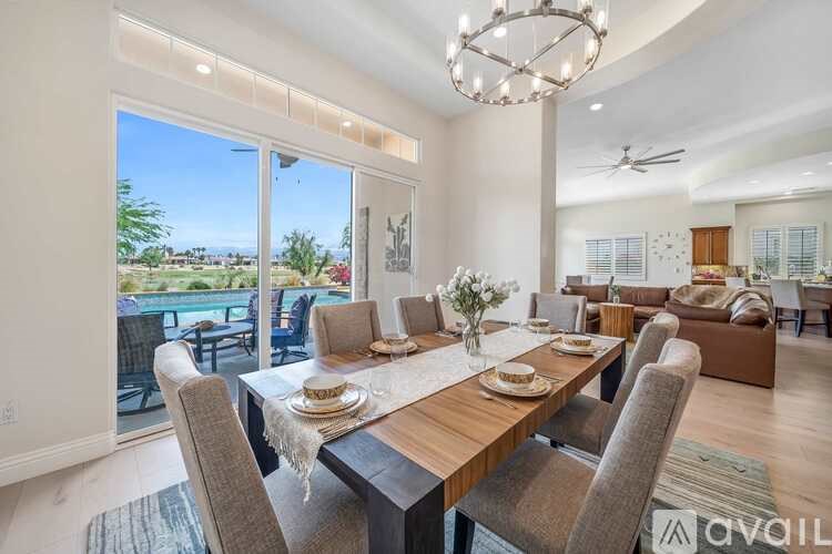 A dining room with a table set for a meal.