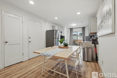A dining area with a table and chairs is shown in the image.