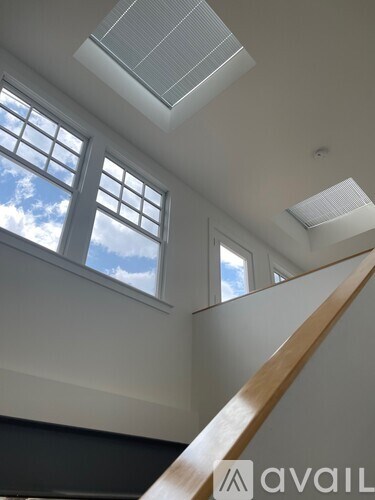 A white room with a skylight and a window.
