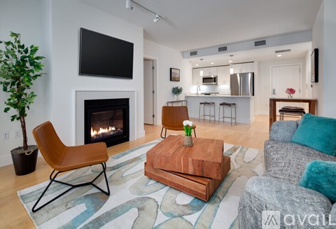A living room with a fireplace and a tv on the wall.