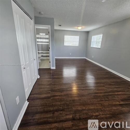 A room with wooden floors and white walls.