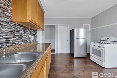 A kitchen with a stainless steel refrigerator and stove.