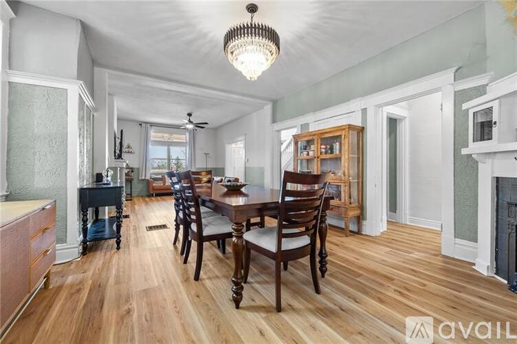 A dining room with a wooden table and chairs.