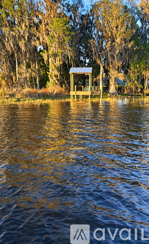 A small wooden structure sits in the middle of a body of water.