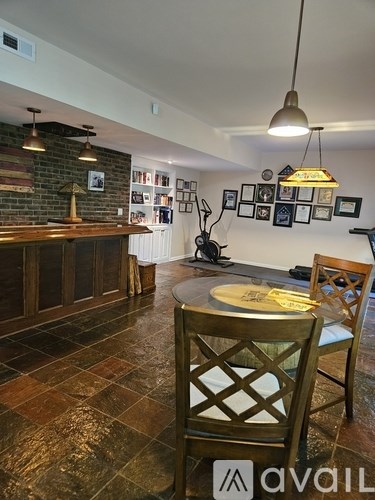 A dining room with a table and chairs.