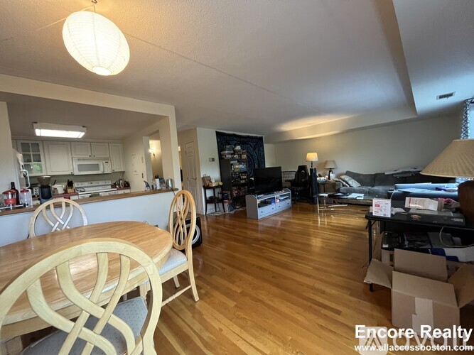 A dining room with a wooden table and chairs.